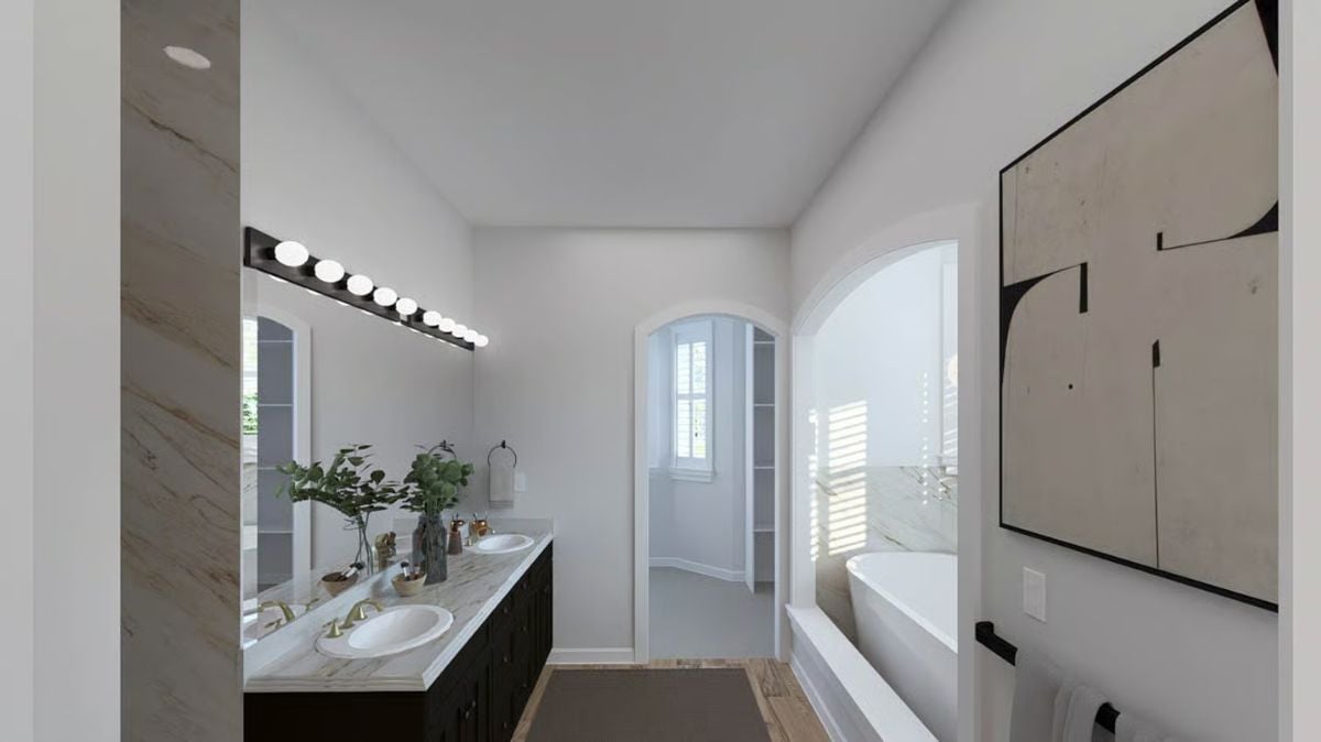 Gold Faucets and Marble Countertops Bring Contrast to a White Master Bath