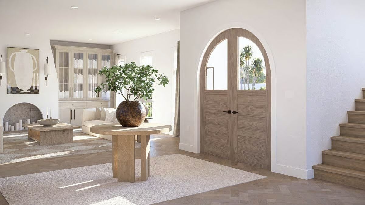 Arched Entry Doors Anchor a Sun-Drenched Foyer with Natural Wood Tones