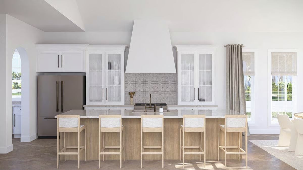 Marble Island and Fluted Glass Cabinets Define a Kitchen Built for Coastal Living