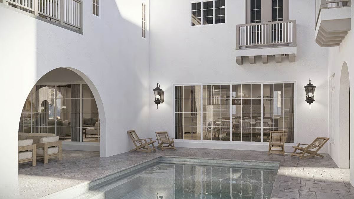 Courtyard Pool Framed by Arched Doorways and Wrought Iron Lanterns