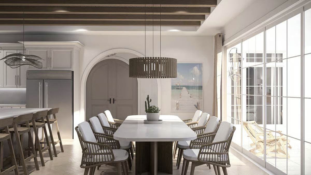 Slat Pendant and Arched Doorway Anchor an Open Dining Room Near the Coast