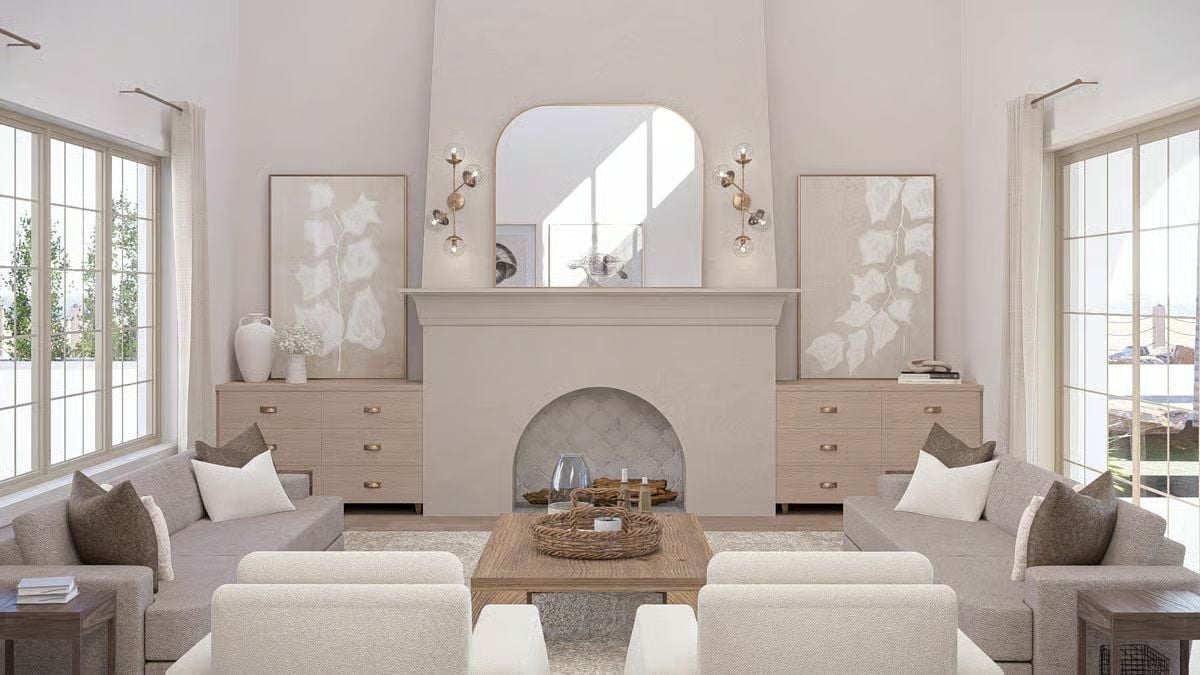Warm Neutrals and Arched Fireplace Anchor This Coastal Living Room