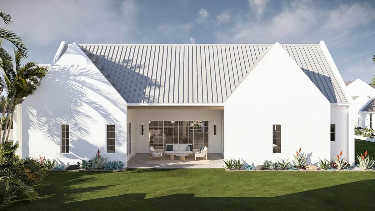 Covered Patio Opens to a Manicured Backyard on This Coastal Home