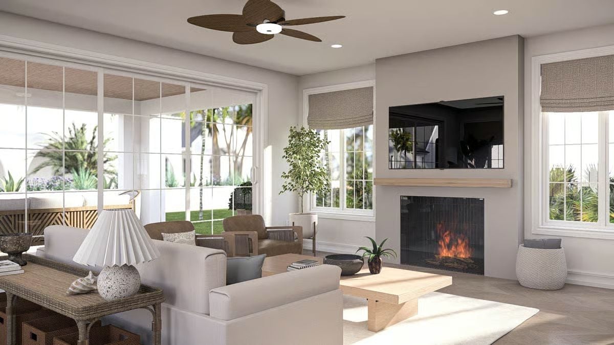 Fireplace Wall with Mounted TV Anchors a Light-Filled Coastal Living Room