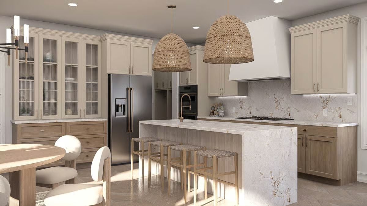Rattan Pendants and Marble Waterfall Island Anchor a Coastal Kitchen