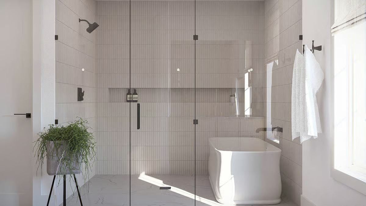Vertical Tile, Glass Walls, and a Soaking Tub Tucked Into the Shower Zone