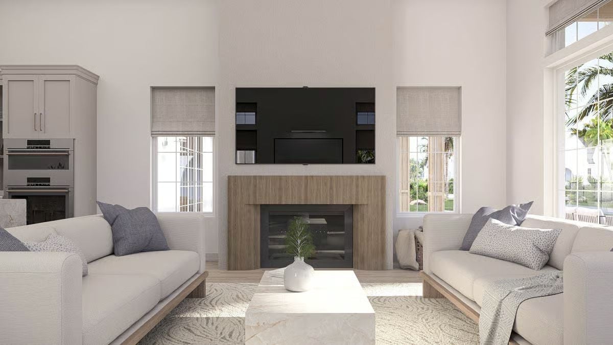 Flanking Sofas and a Fluted Fireplace Surround Define This Coastal Living Room