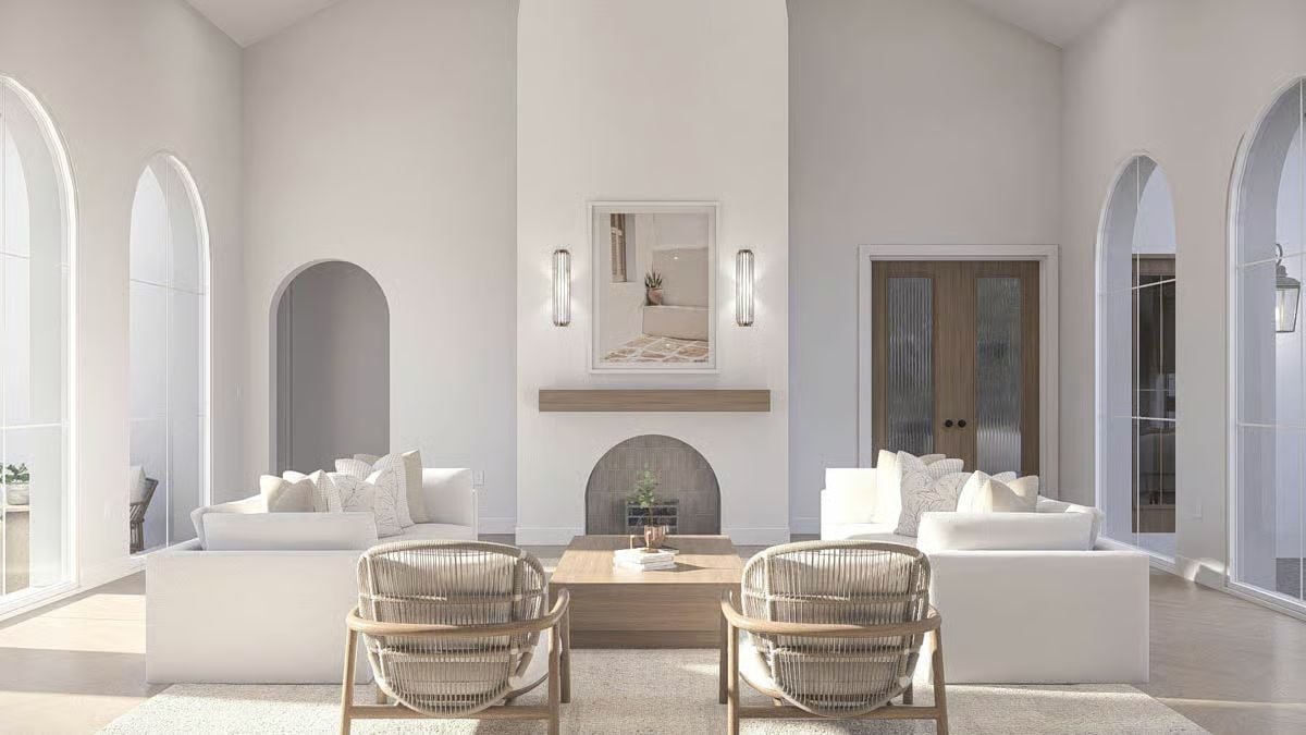 Vaulted Ceilings and Woven Chairs Ground a Living Room in Warmth