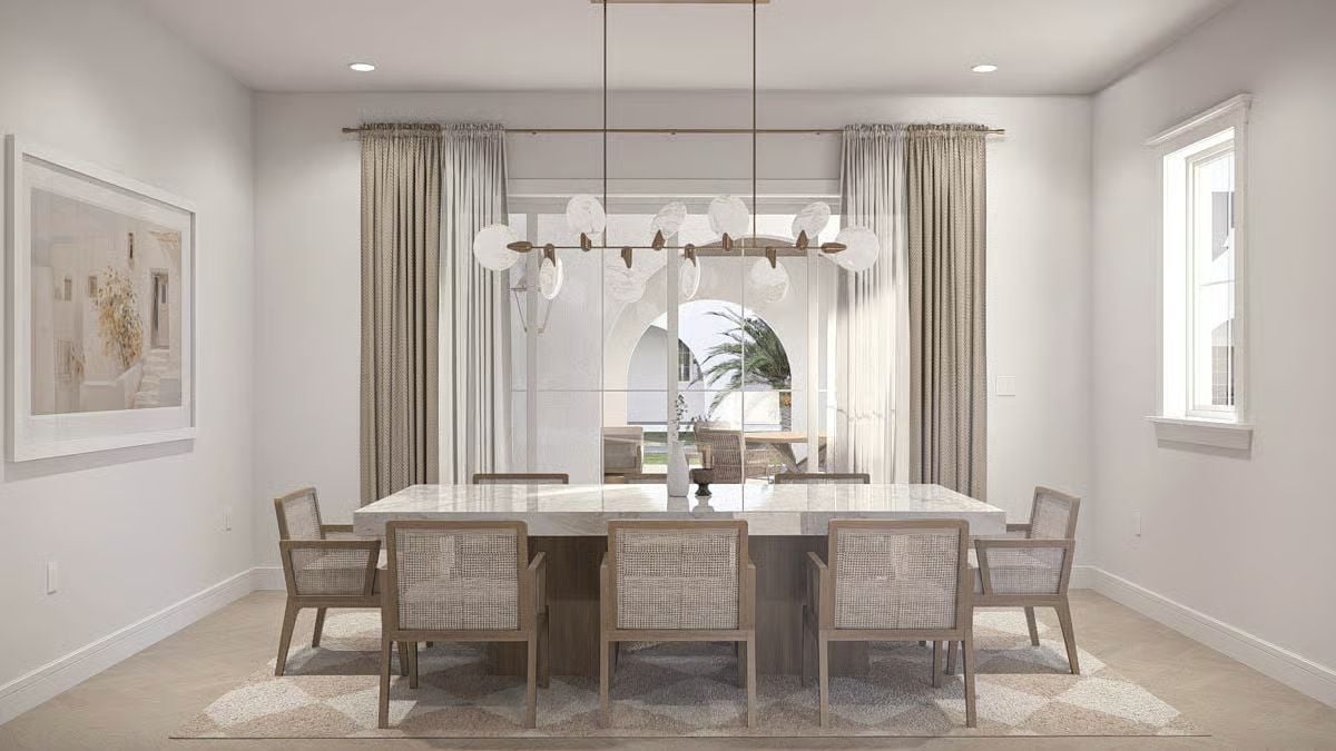 Globe Pendants and Woven Cane Chairs Define a Dining Room Built for Coastal Living