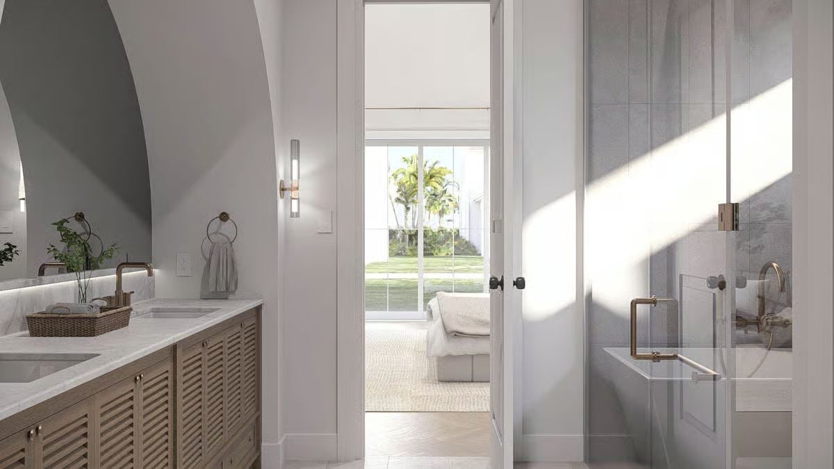 Brass Fixtures and Gray Tile Give a Primary Bath Its Coastal Edge