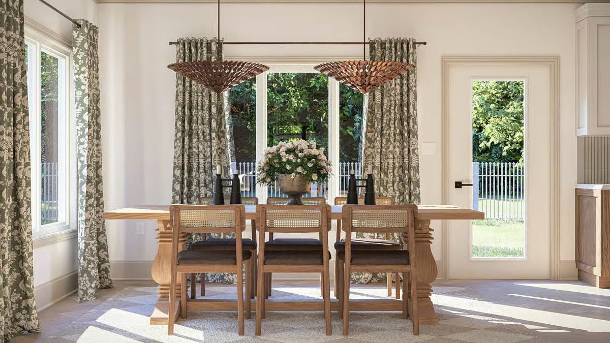Cane-Back Chairs and Carved Pedestals Ground a Sun-Filled Dining Room