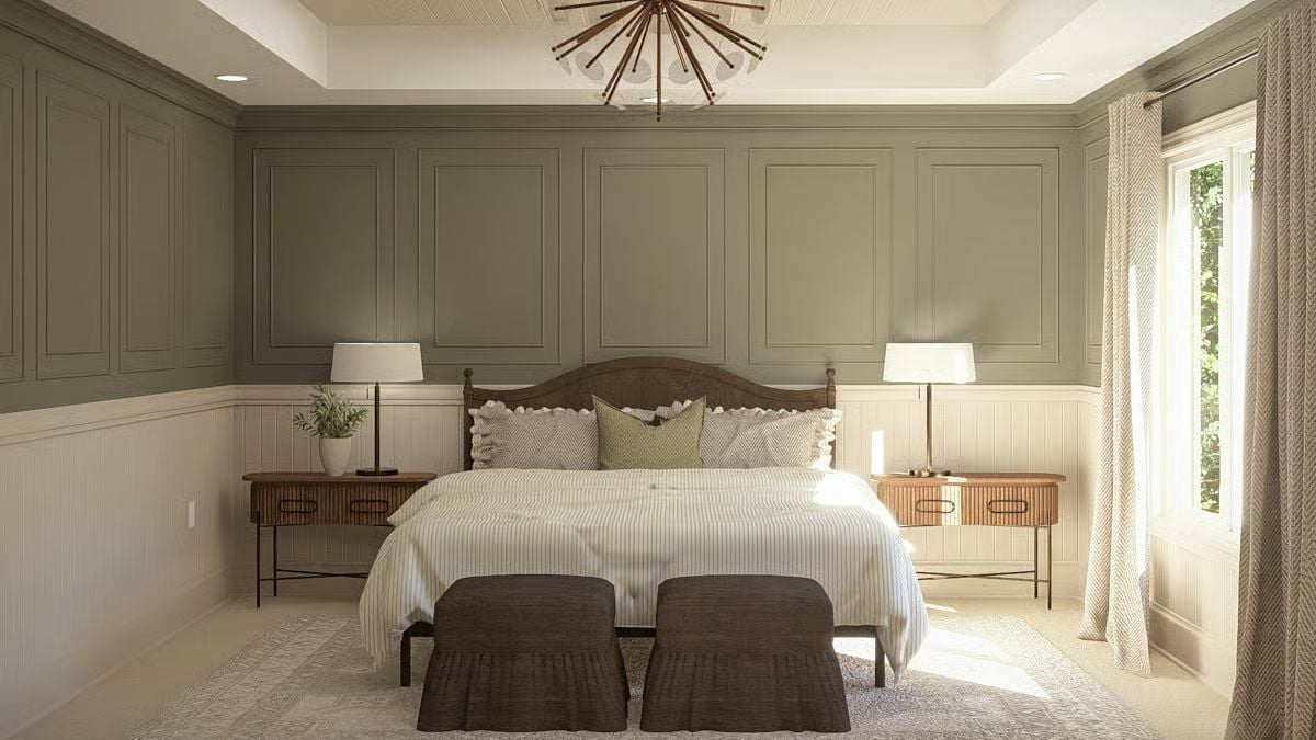 Sage Paneling and a Carved Headboard Shape a Calm Primary Bedroom