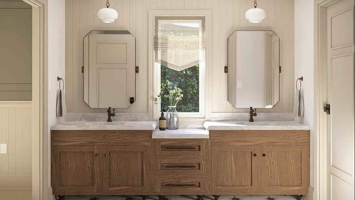 Octagonal Mirrors and Warm Oak Cabinets Define a Double Vanity Worth Studying