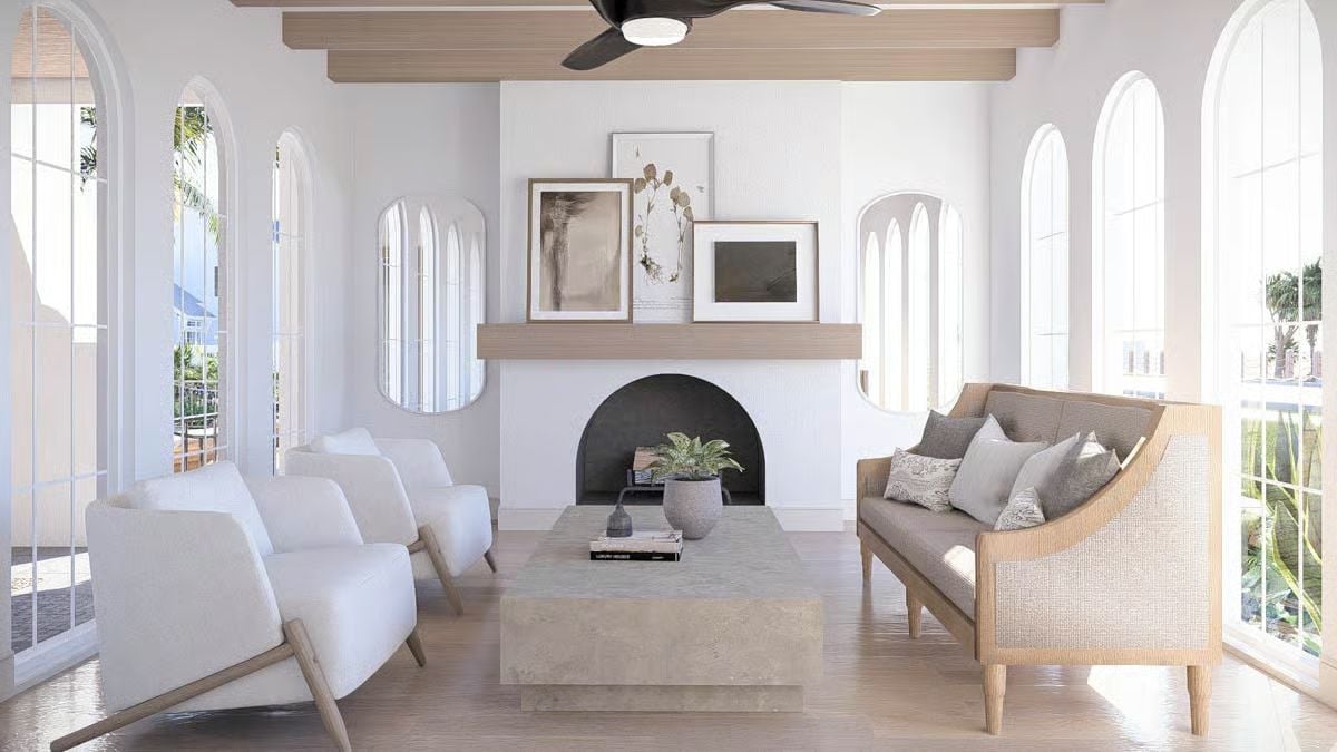 Arched Windows and a Dark Fireplace Anchor This Coastal Living Room