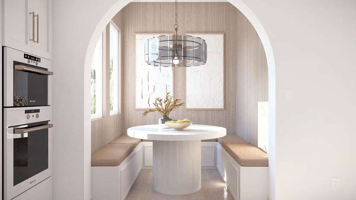 Built-In Banquette Nook Framed by an Arched Passageway