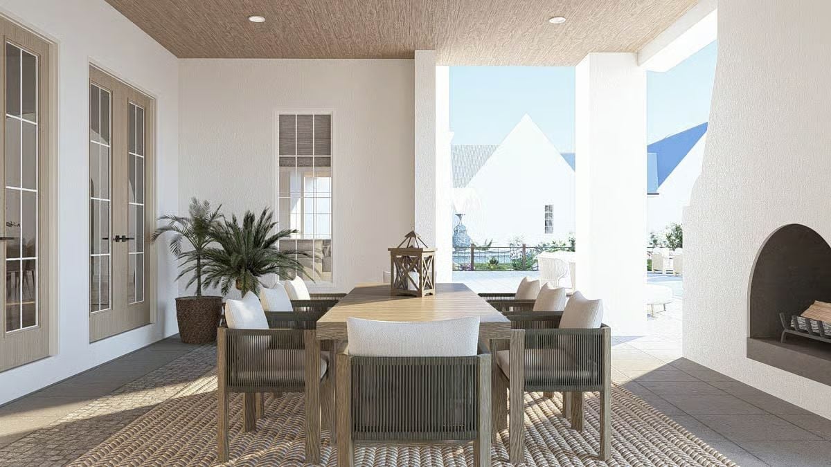 Covered Patio Dining Area Opens to a Pool Terrace Beyond