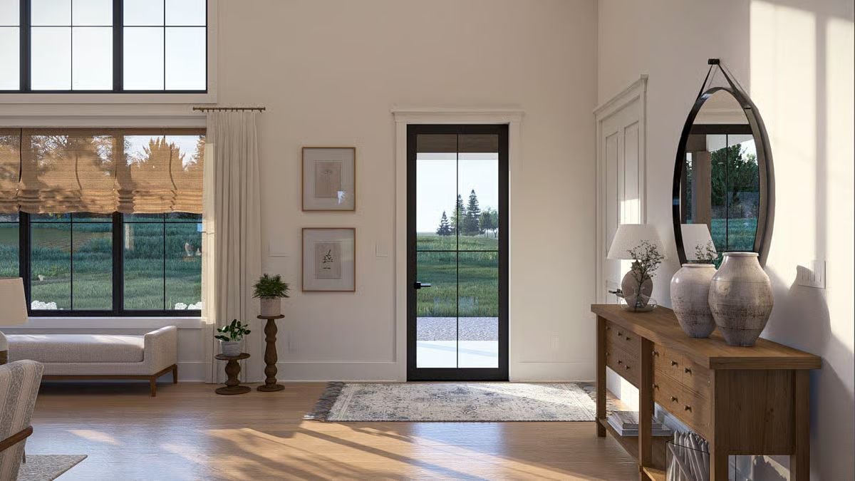 Oval Mirror, Warm Wood Credenza, and a Glass Door That Pulls You Outside