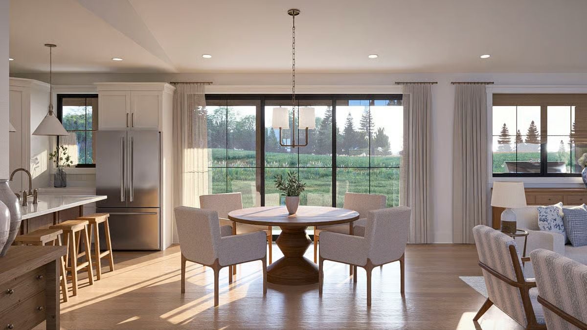 Round Pedestal Table and Floor-to-Ceiling Glass Keep Dinner Feeling Open