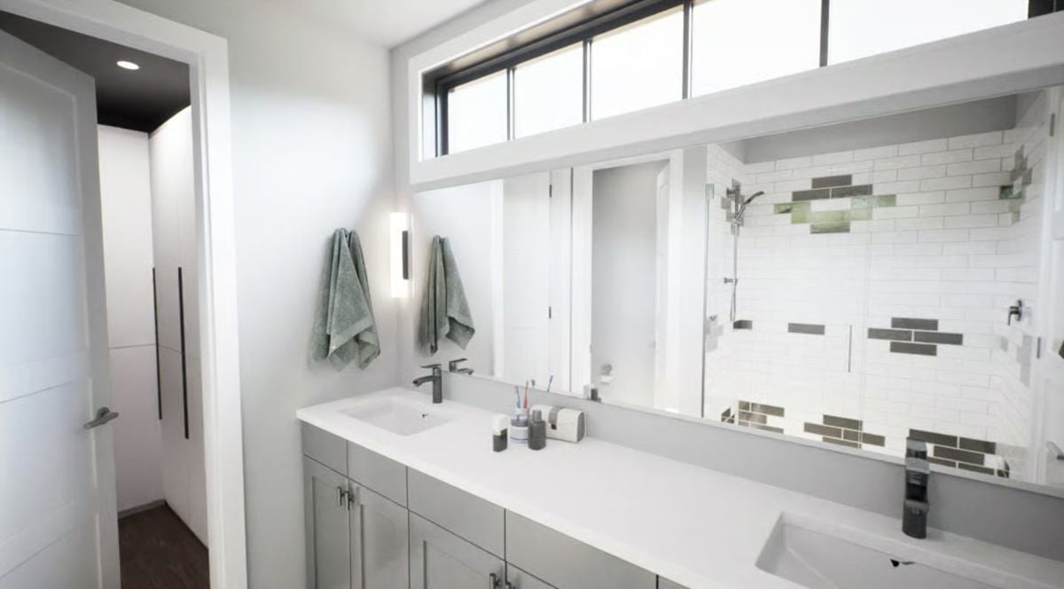 Double Vanity Bathroom With Subway Tile Shower and Clerestory Window