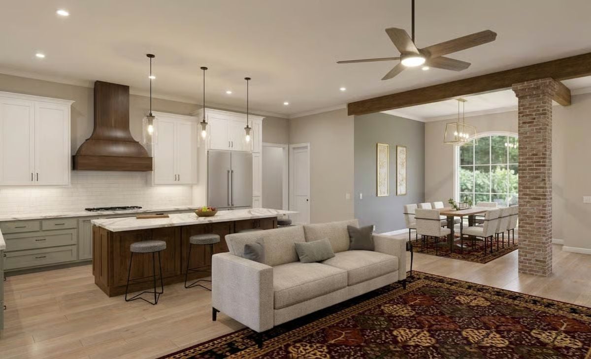 Wood Range Hood and Sage Cabinets Anchor a Kitchen Built for Gathering