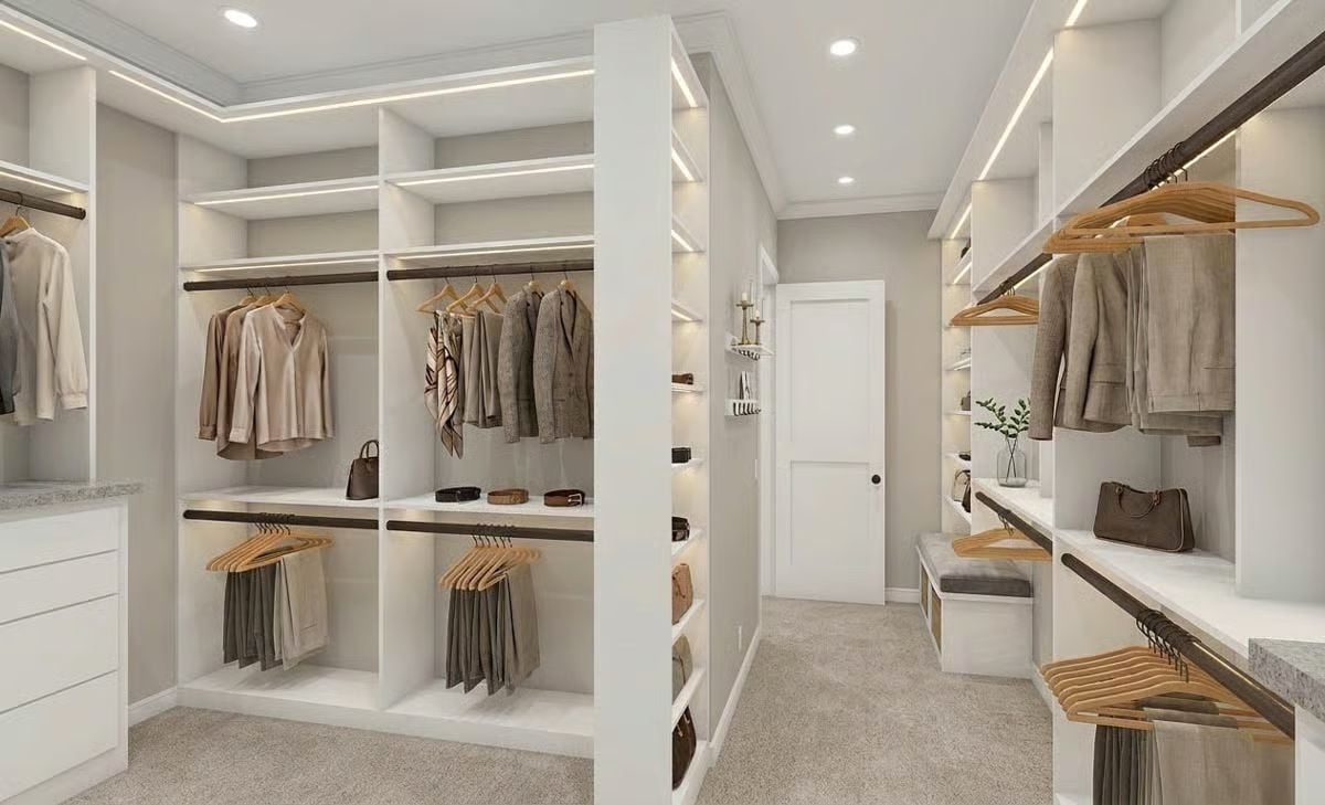 Carpet, Recessed Lighting, and Wood Hangers Keep a Walk-In Closet Grounded