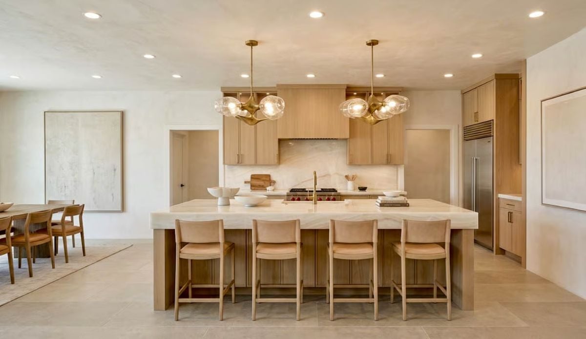 Warm Wood Cabinetry and Brass Pendants Define This Open-Plan Kitchen