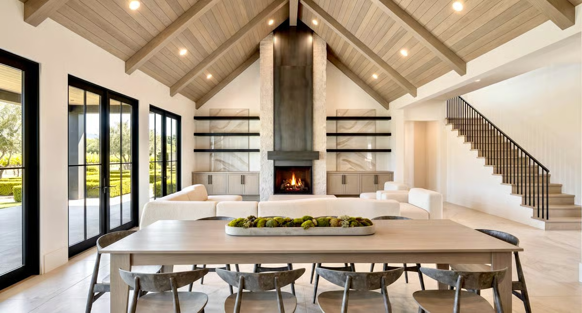 Vaulted Beams and a Stone Fireplace Anchor the Open Living Space