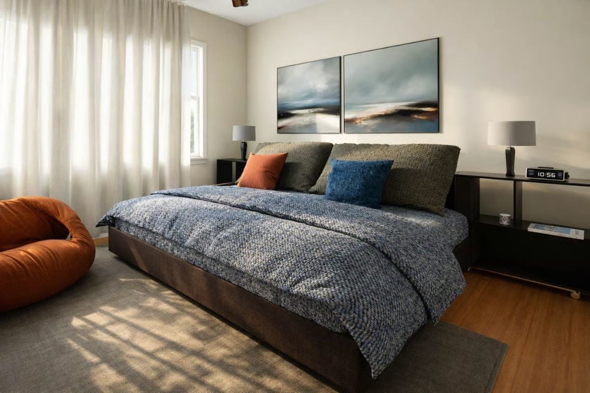 Blue Bedding and Layered Pillows Ground a Moody Primary Suite