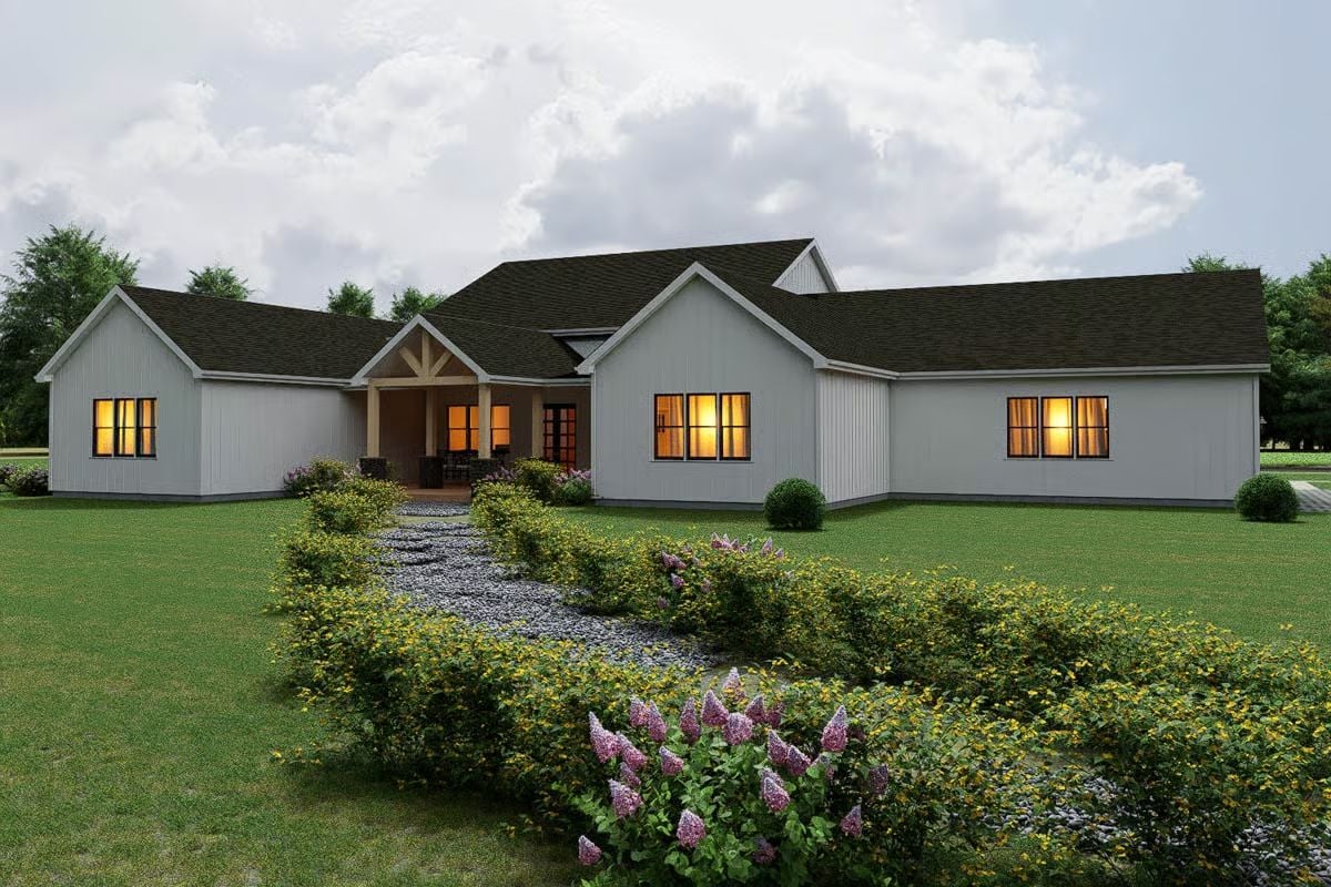 Covered Patio and Warm Glow Give This Farmhouse Rear Elevation Its Character