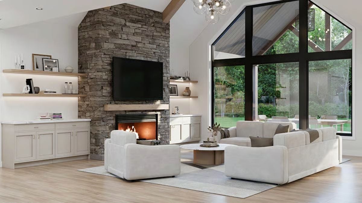 Stone Fireplace Wall Anchors a Vaulted Great Room with Floor-to-Ceiling Glass