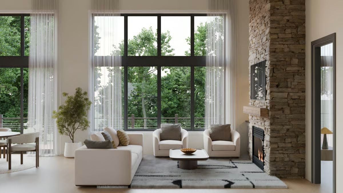 Floor-to-Ceiling Stone Fireplace Anchors a Light-Filled Mountain Living Room