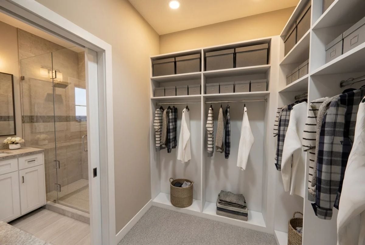 Built-In Shelving and Dual Hanging Rods Make the Most of Walk-In Closet Space