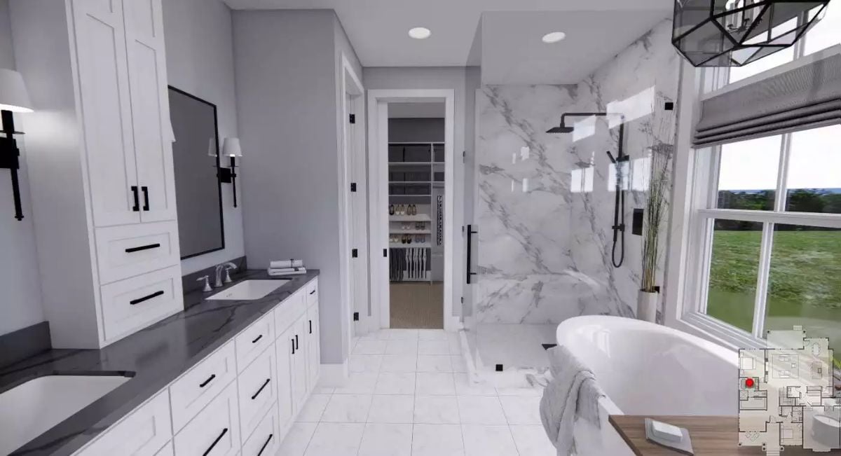 Marble Shower Wall, Freestanding Tub, and a Walk-In Closet Straight Ahead