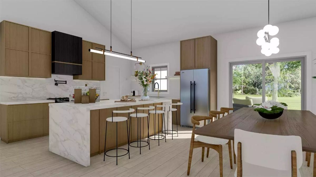 Marble Island Kitchen Opens Into Dining and Outdoor Views