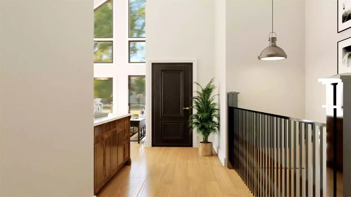 Bold Black Door and Warm Wood Tones Meet in This Upper Hallway