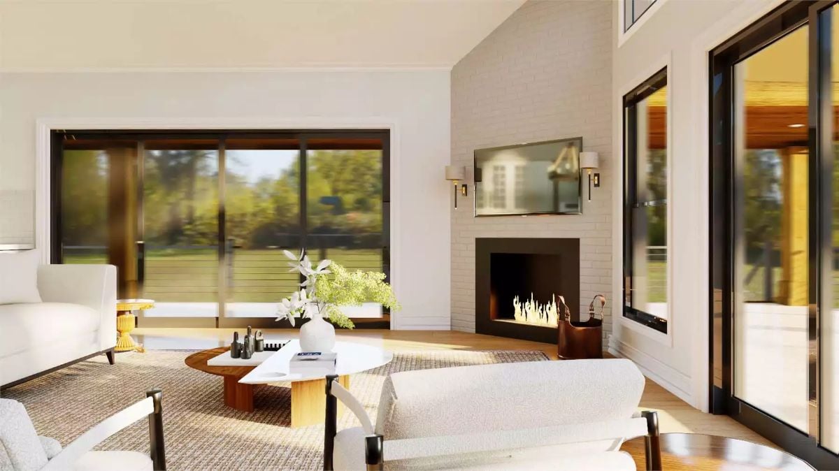 White Brick Fireplace and Vaulted Ceiling Anchor This Sun-Filled Living Room