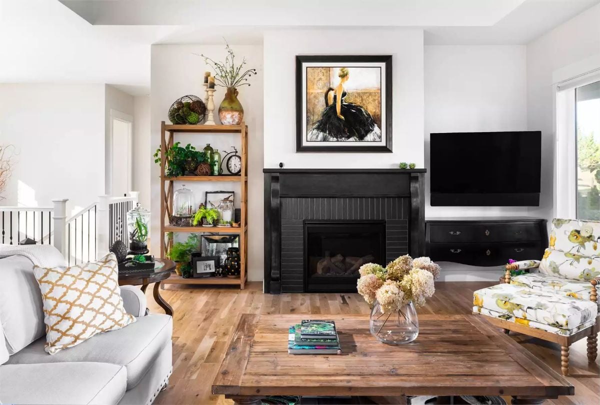 Black Fireplace Surround Anchors a Living Room Built Around Natural Wood