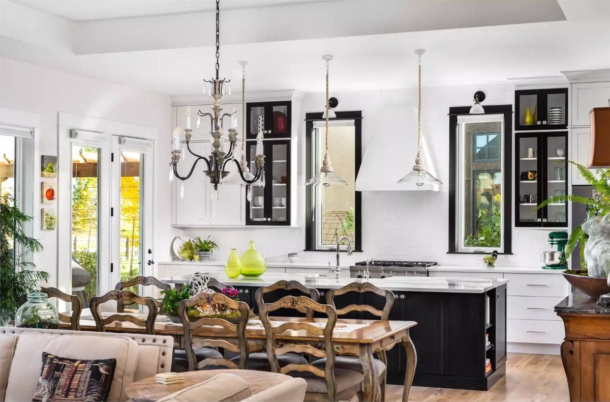 Black Cabinet Frames and Candle Chandelier Define an Open Kitchen Worth Gathering In