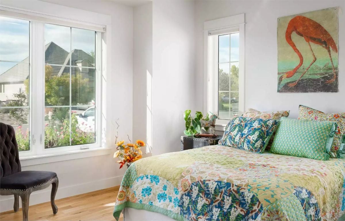 Flamingo Wall Art and Floral Bedding Bring Bold Color to a Sun-Filled Corner Bedroom