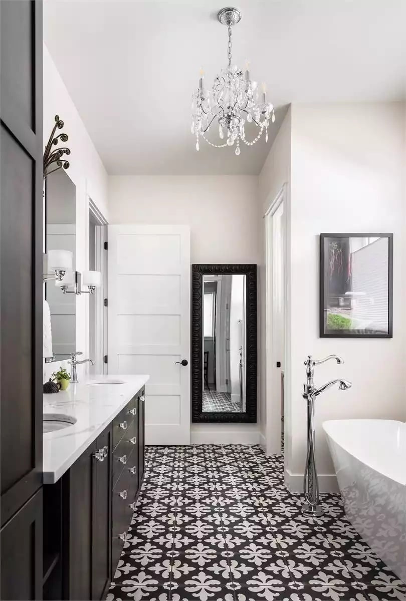 Crystal Chandelier and Patterned Floor Tile Pull a Bathroom Into Sharp Focus