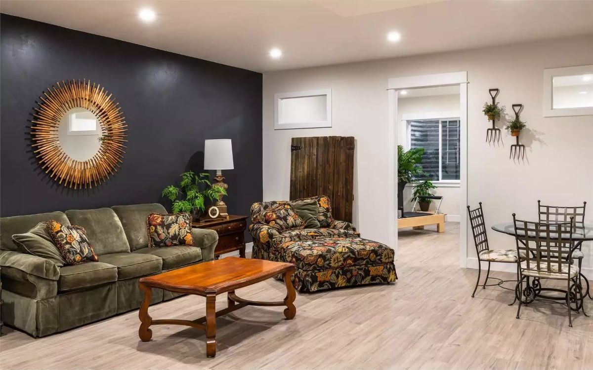 Sunburst Mirror and Dark Accent Wall Set the Tone for an Eclectic Living Space