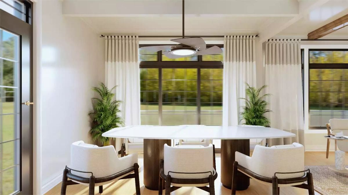Oval Dining Table Anchored by Cylinder Pedestals Grounds an Airy, Sun-Filled Room