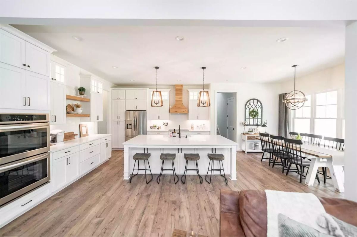 White Cabinetry and Wood Accents Anchor an Open-Concept Kitchen and Dining Space