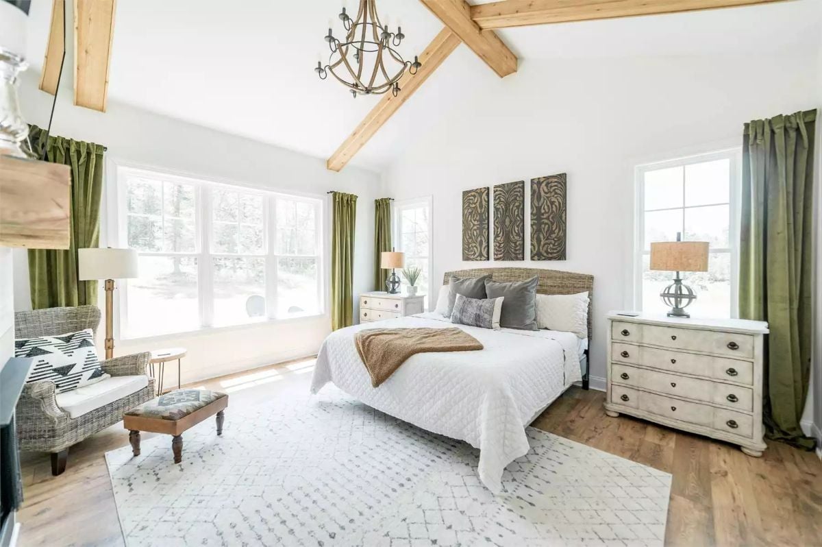 Vaulted Beams and Olive Curtains Shape a Farmhouse Master Bedroom Worth Waking Up In
