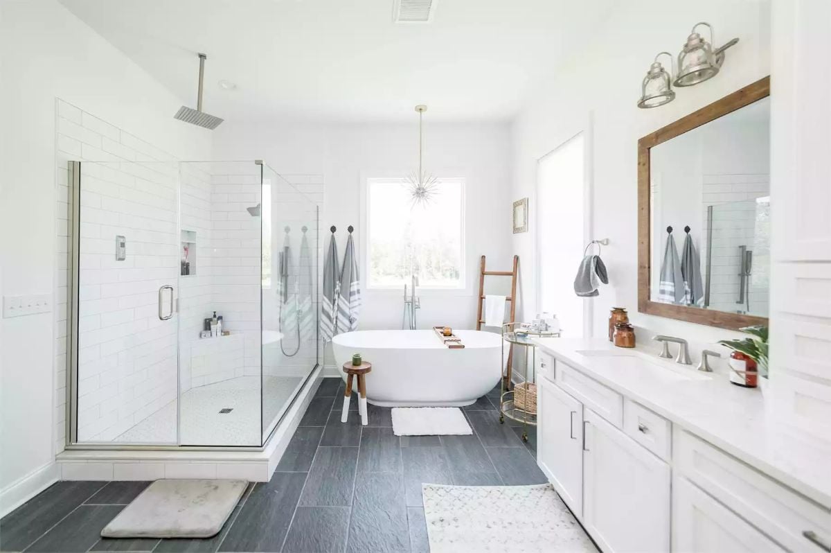 Freestanding Soaking Tub Floats Between Glass Shower and Double Vanity