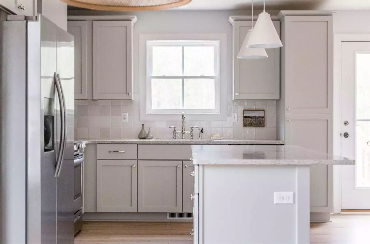 Warm Gray Cabinets and a Bridge Faucet Anchor a Quiet, Collected Kitchen