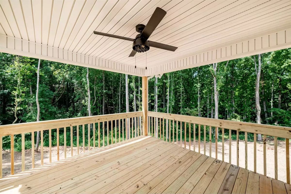 Covered Deck Floats Above the Trees with Open Railings and a Ceiling Fan