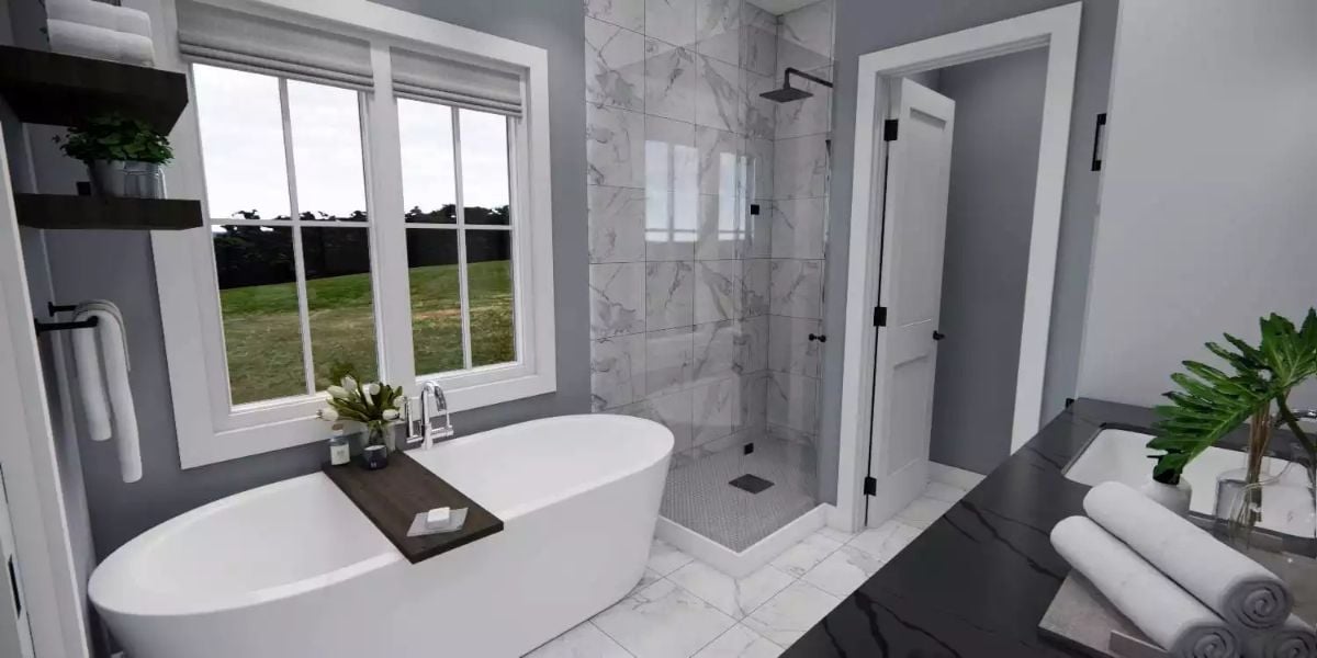 Freestanding Soaking Tub Sits Beside Marble Shower in a Gray Master Bath