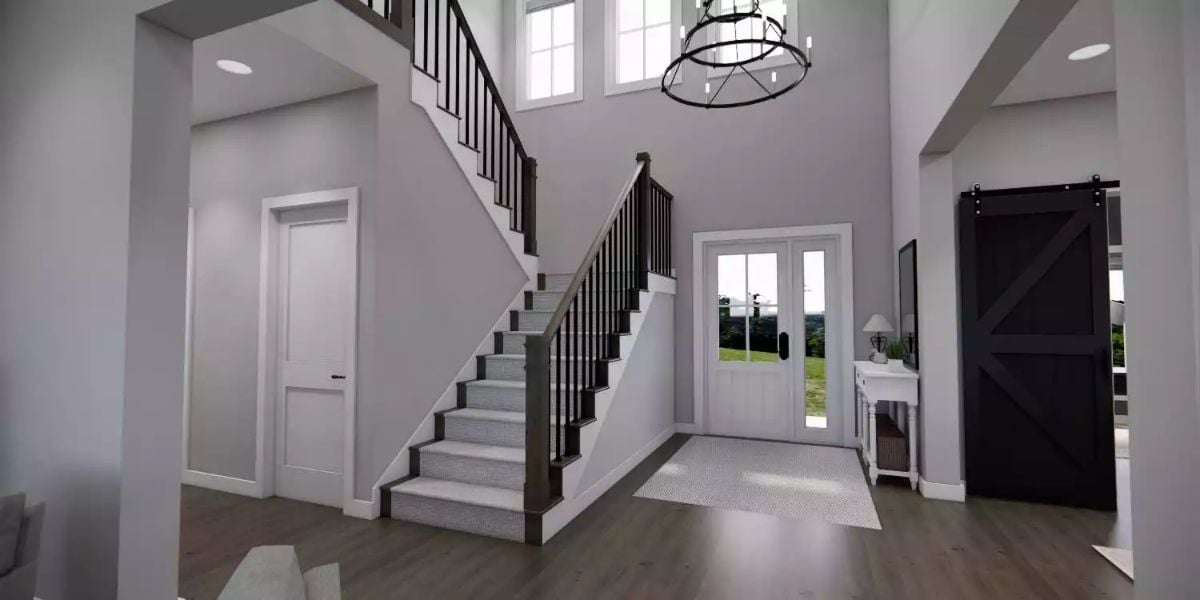 Grand Two-Story Foyer with Barn Door and Wraparound Staircase