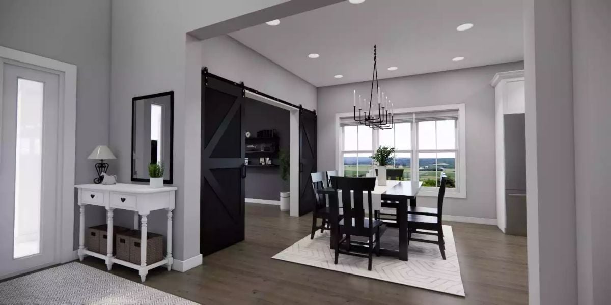 Black Barn Door Slides Between Entryway and Dining Room with Chandelier